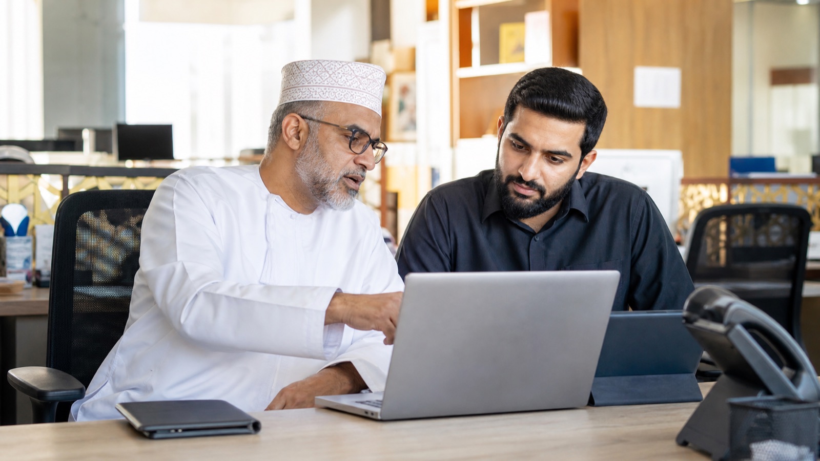 Oman business professionals working on Cybersecurity Checklist for Oman SMEs