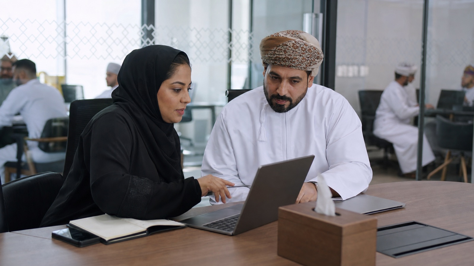Oman workplace team reviewing Microsoft 365 security and collaboration controls