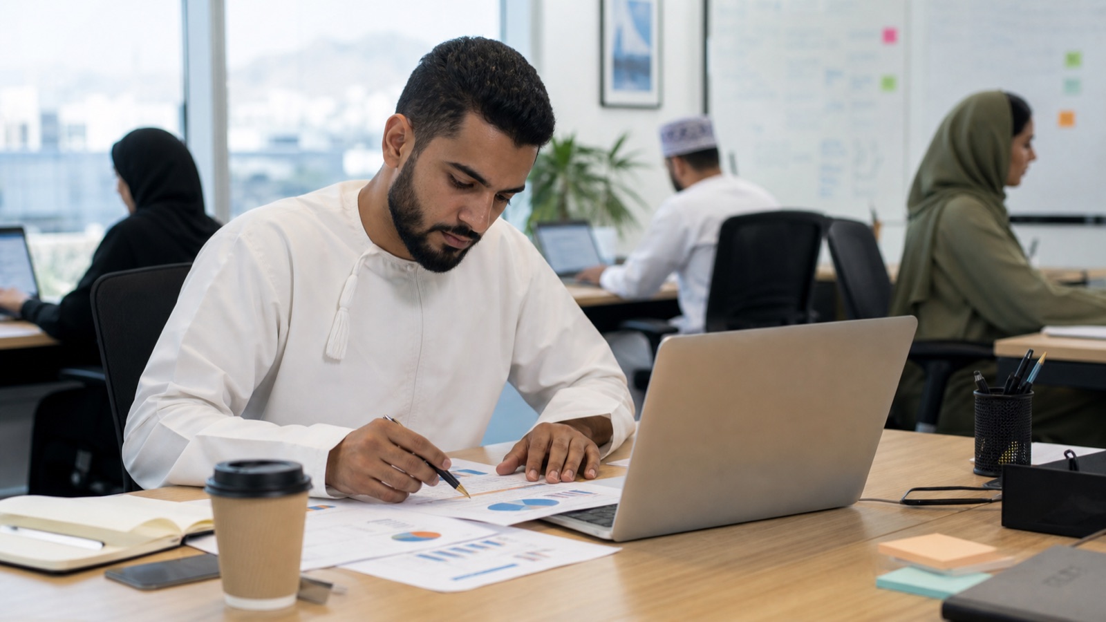 Oman business professionals working on SEO vs Google Ads in Oman: How to Allocate Budget