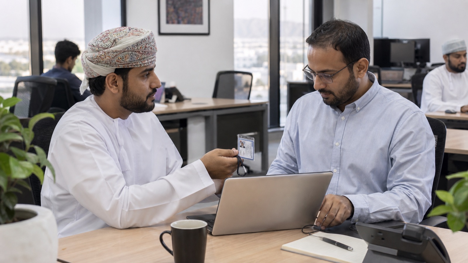 Omani IT team reviewing identity and device controls in a server room
